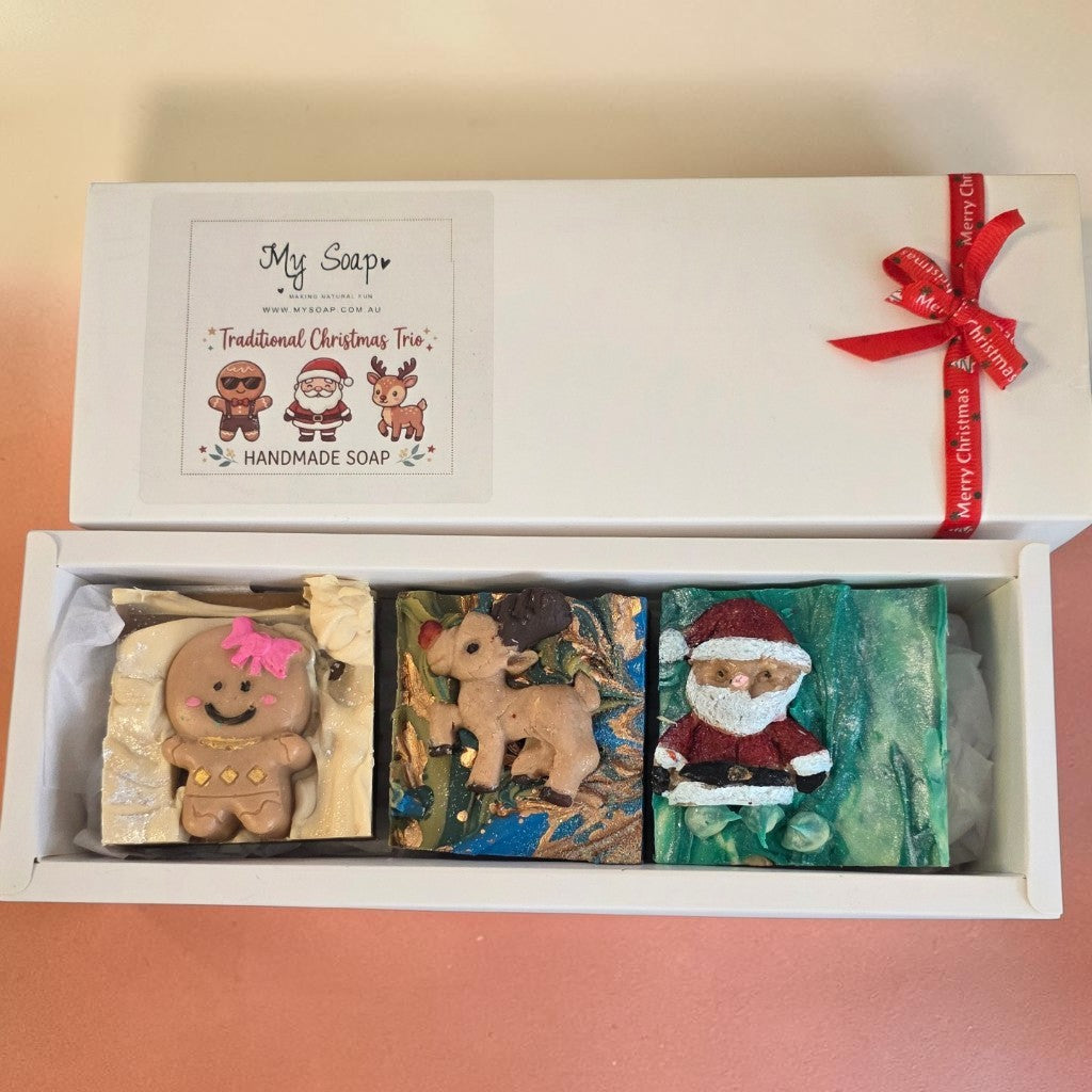 My Soap Traditional Christmas Trio gift set featuring handmade gingerbread, reindeer, and Santa soaps in a white box.
