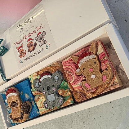 My Soap Aussie Christmas Trio gift set featuring handmade kangaroo, koala, and platypus soaps wearing Santa hats.