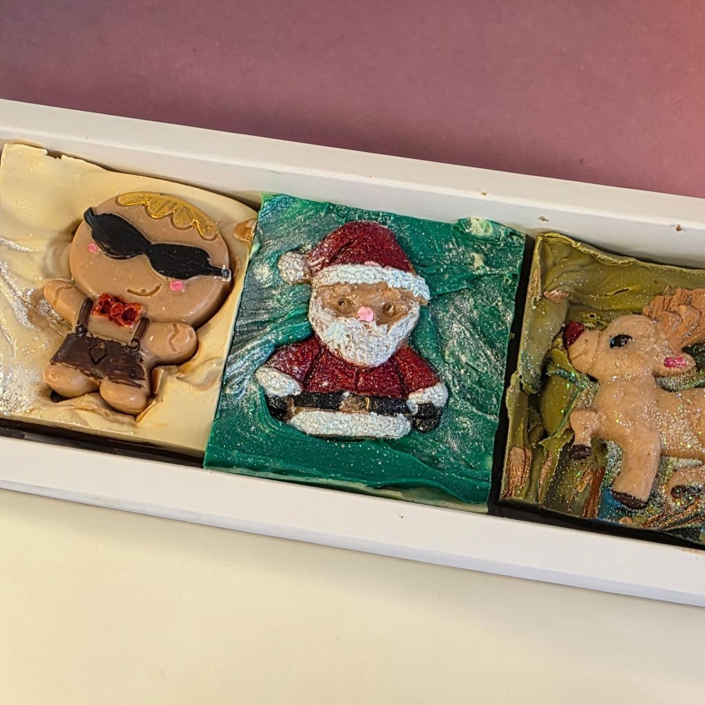 My Soap Traditional Christmas Trio gift set featuring handmade gingerbread, Santa, and reindeer soaps in a white box.