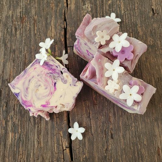 My Soap Sweet Pea & Jasmine artisanal soap with swirls of purple and cream, topped with white and purple floral accents.